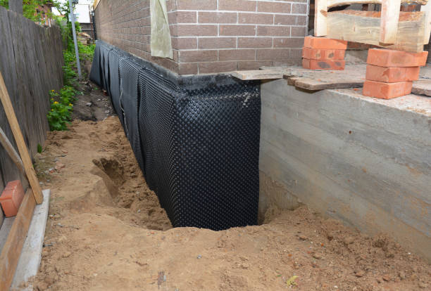 SJ Waterproofing Pros technician performing targeted Exterior Waterproofing assessment in Clinton Township, MI